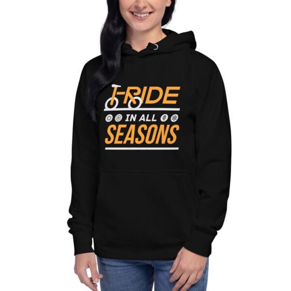 Young woman wearing premium hoodie in black with text "I ride in all seasons" and small seasons icons