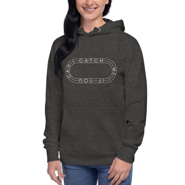 Young woman wearing premium hoodie in charcoal heather with white running track with text "Catch me if you can" inside