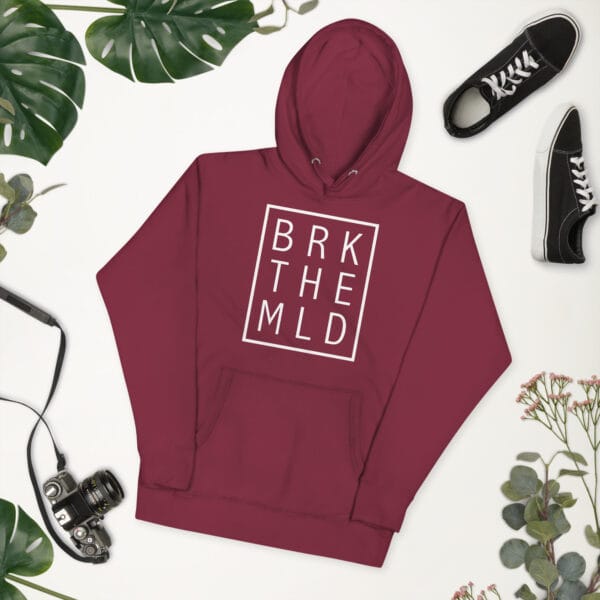 Unisex premium hoodie in maroon with white rectangle and letters "BRK THE MLD" inside meaning 'break the mould'