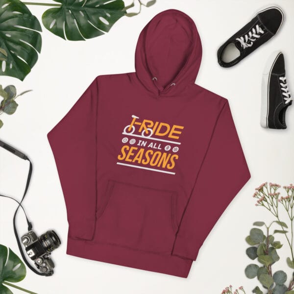 Unisex premium hoodie in maroon with text "I ride in all seasons" with I and R making a bike