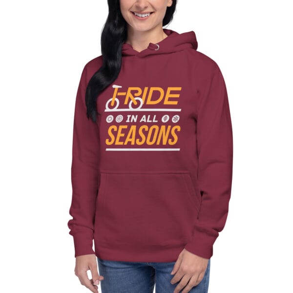 Young woman wearing premium hoodie in maroon with text "I ride in all seasons" and small seasons icons