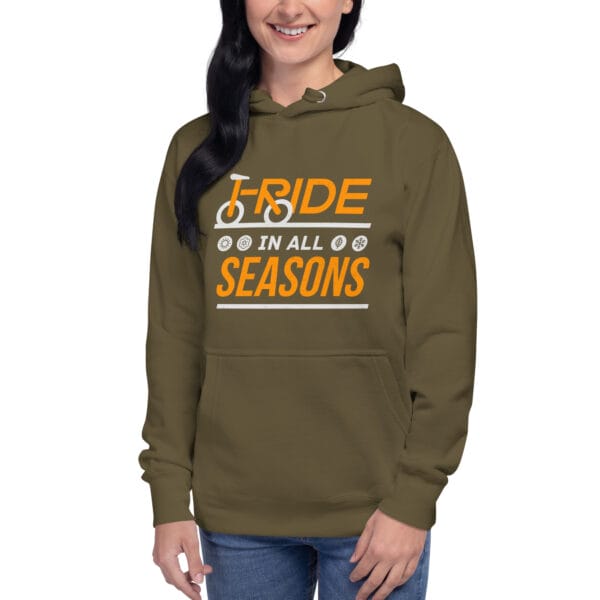 Young woman wearing premium hoodie in military green with text "I ride in all seasons" and small seasons icons