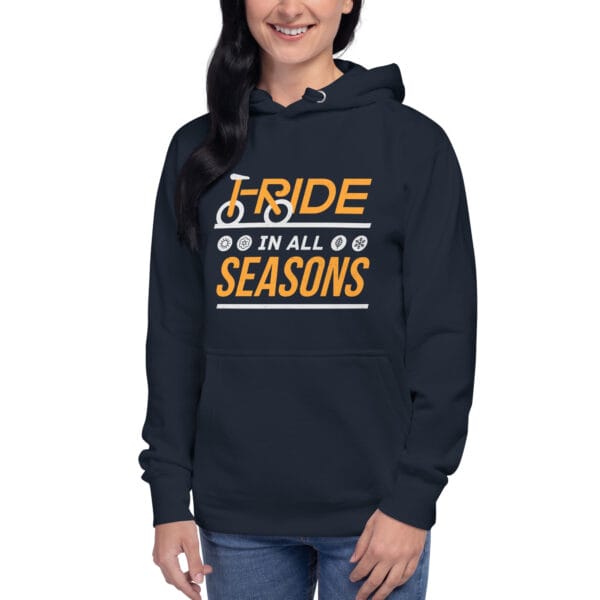 Young woman wearing premium hoodie in navy with text "I ride in all seasons" and small seasons icons