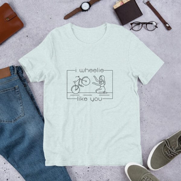 Unisex staple t-shirt in ice blue with a bike and girl about to embrace with text "I wheelie like you"