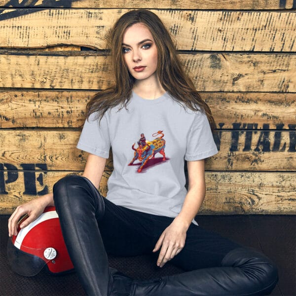 Young woman sat leaning against wall wearing light blue t-shirt with max verstappen sat arms folded on top of a raging bull