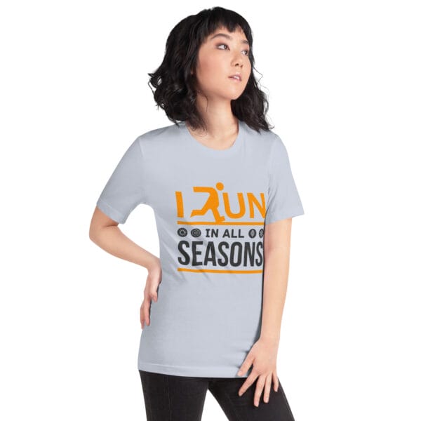 Young woman wearing a light blue staple t-shirt with text "I run in all seasons" with the letter R a silhouette of a runner