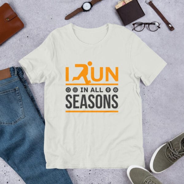 Unisex staple t-shirt in silver with text "I run in all seasons" with the letter R a silhouette of a runner