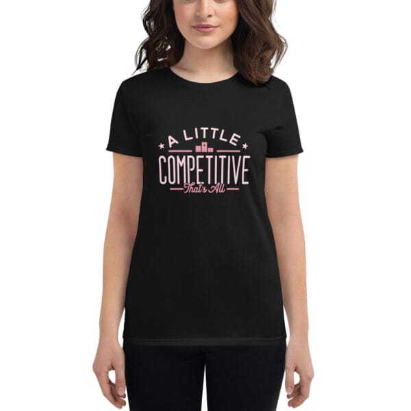 Women's short sleeve t-shirt in black with pink text "A little competitive that's all" on a model