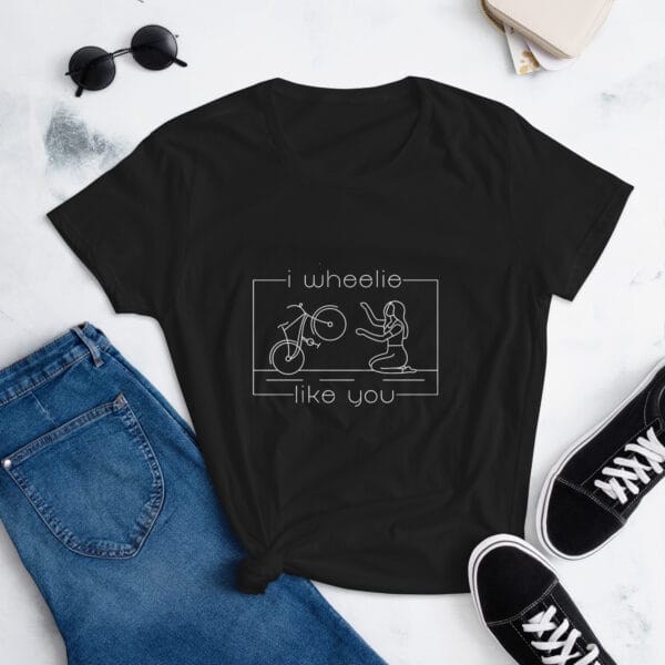 Women's shirt in black with a bike and girl about to embrace with text "I wheelie like you"