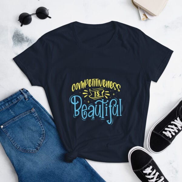 Women's short sleeve t-shirt in navy with yellow and light blue text reading "competitiveness is beautiful"