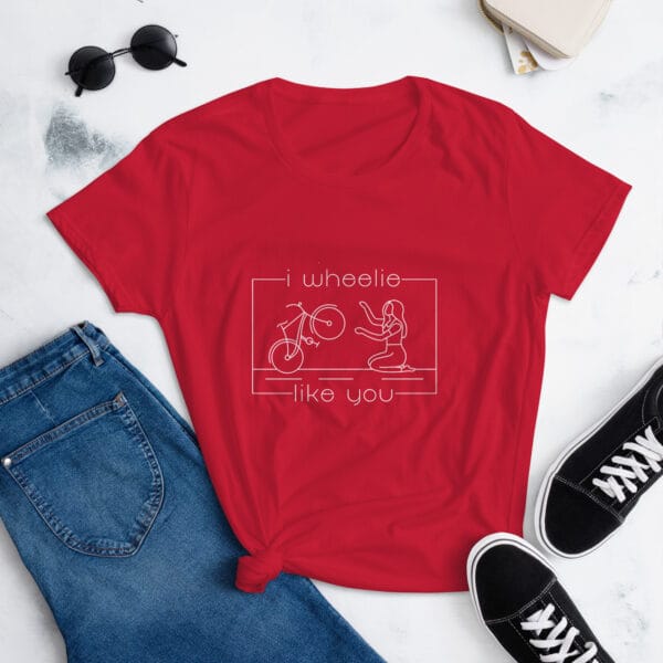 Women's shirt in true red with a bike and girl about to embrace with text "I wheelie like you"