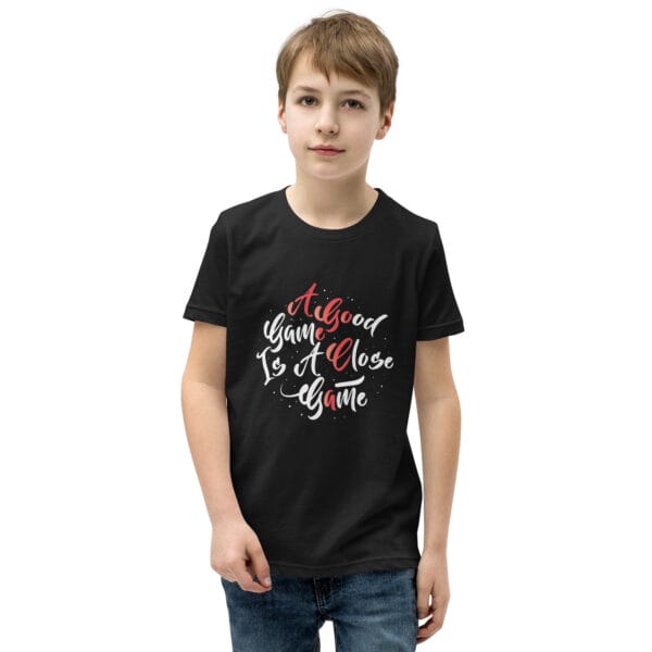 Young boy wearing black youth staple t-shirt with text 'A good game is a close game'