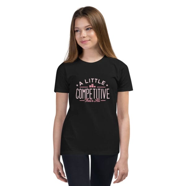 Young girl wearing a black youth staple t-shirt with text 'A little competitive, that's all'