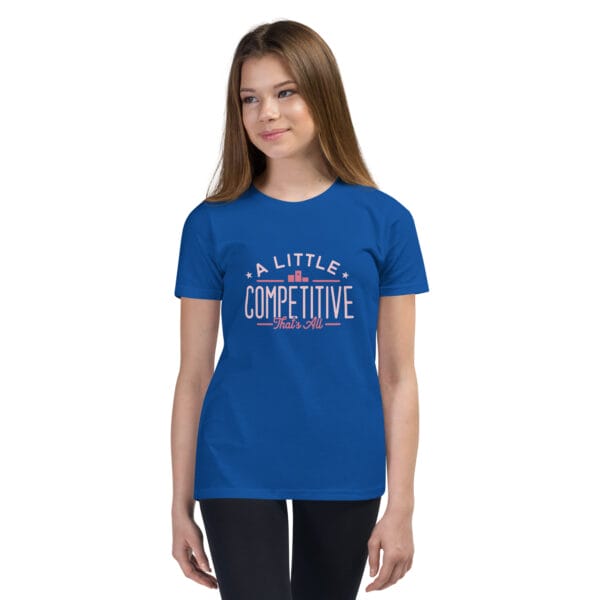 Young girl wearing a royal blue youth staple t-shirt with text 'A little competitive, that's all'