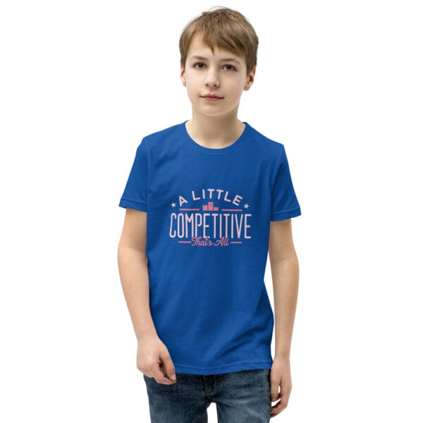 Young boy wearing a royal blue youth staple t-shirt with text 'A little competitive, that's all'