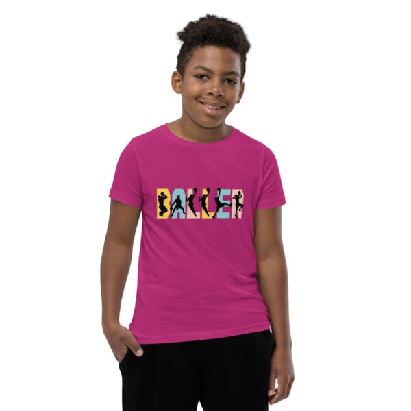 Young boy wearing staple t-shirt in berry with the text 'baller' and black basketball player silhouettes in each letter