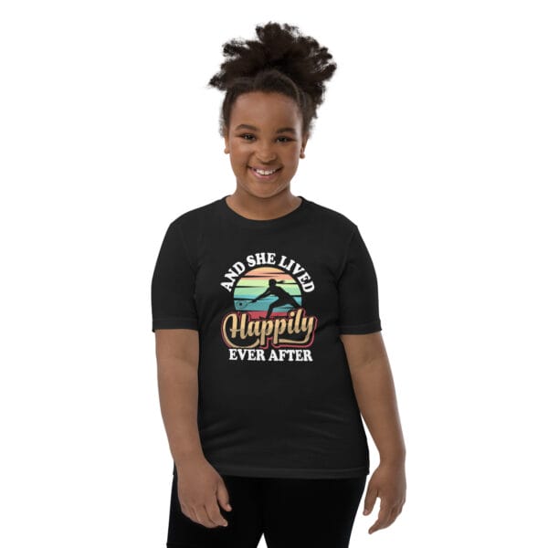 Young black girl wearing staple black t-shirt with tennis player silhouette in front of colourful background and text 'And she lived happily ever after'