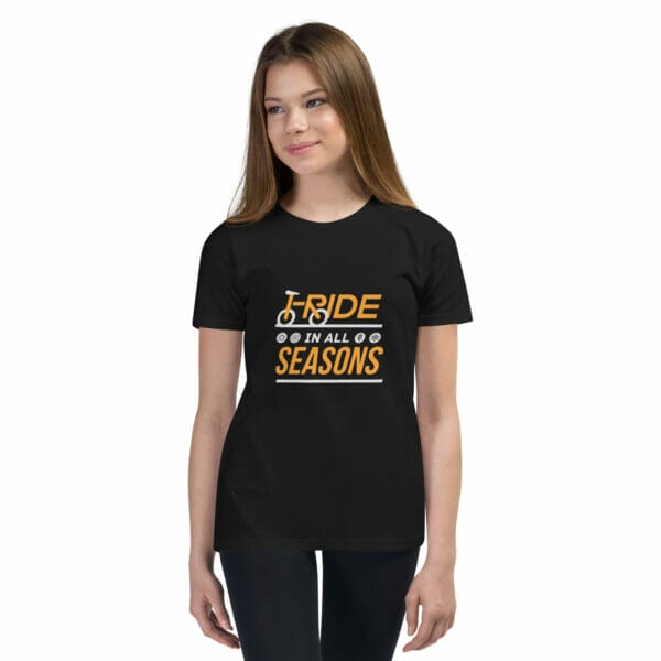 Young girl wearing a black staple t-shirt with text 'I ride in all seasons'