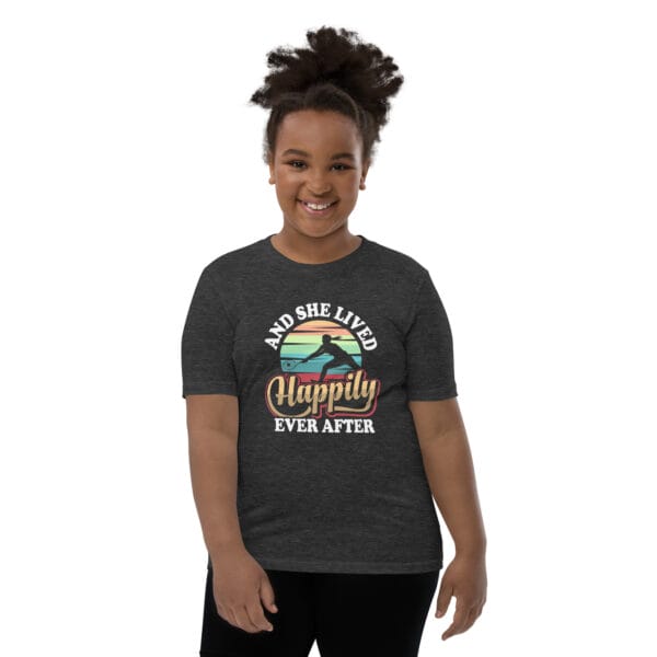 Young black girl wearing staple dark grey heather t-shirt with tennis player silhouette in front of colourful background and text 'And she lived happily ever after'