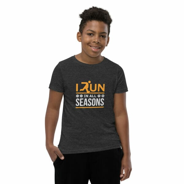 Boy wearing dark grey heather staple t-shirt with text 'I run in all seasons' and small seasonal icons