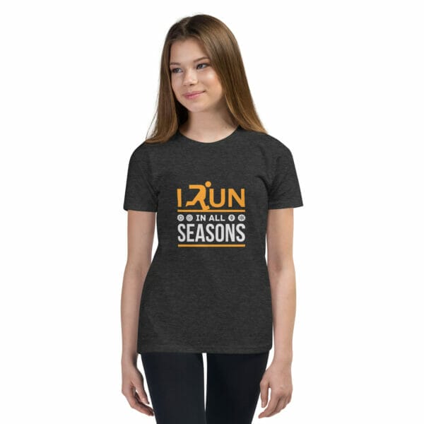 Girl wearing dark grey heather staple t-shirt with text 'I run in all seasons' and small seasonal icons