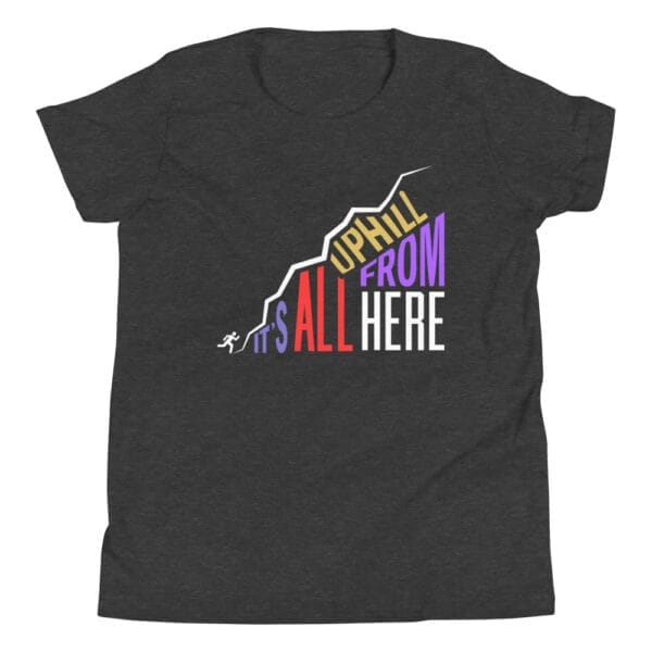 Youth dark grey heather staple t-shirt with text "It's all uphill from here" in shape of a hill