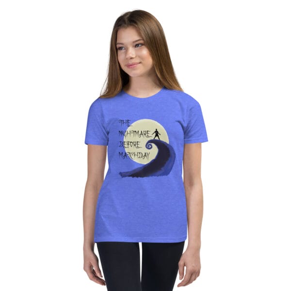 Young girl in heather columbia blue staple t-shirt with text 'The nightmare before matchday' and Ronaldo sii silhouette in front of moon