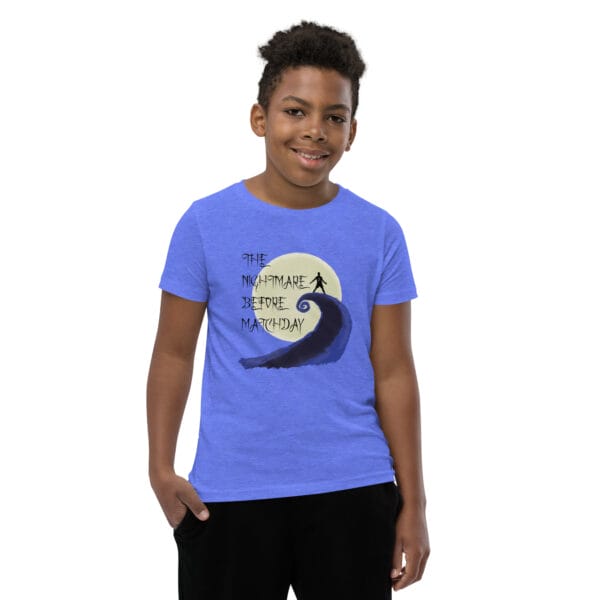 Young boy in heather columbia blue staple t-shirt with text 'The nightmare before matchday' and Ronaldo sii silhouette in front of moon