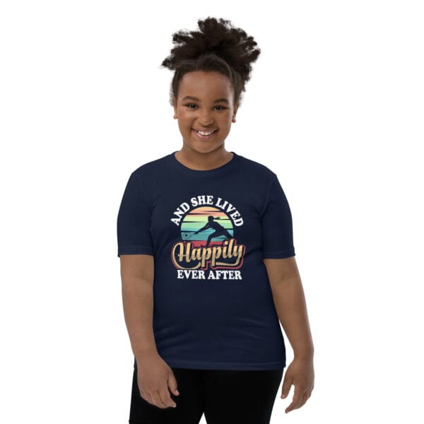 Young black girl wearing staple navy t-shirt with tennis player silhouette in front of colourful background and text 'And she lived happily ever after'