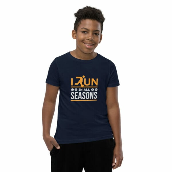 Boy wearing navy staple t-shirt with text 'I run in all seasons' and small seasonal icons