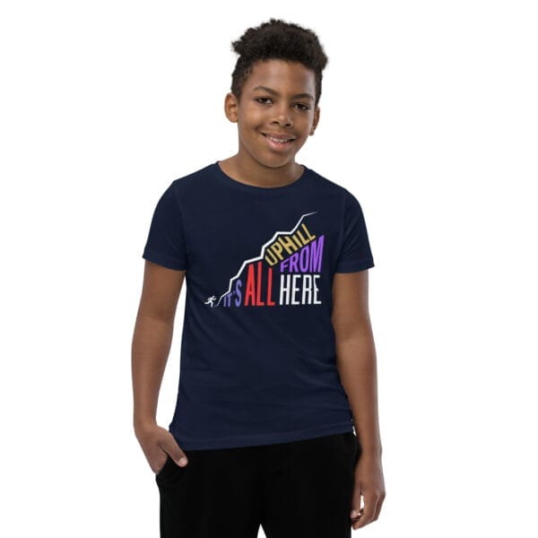 Young boy wearing a navy staple t-shirt with text "It's all uphill from here" in shape of a hill