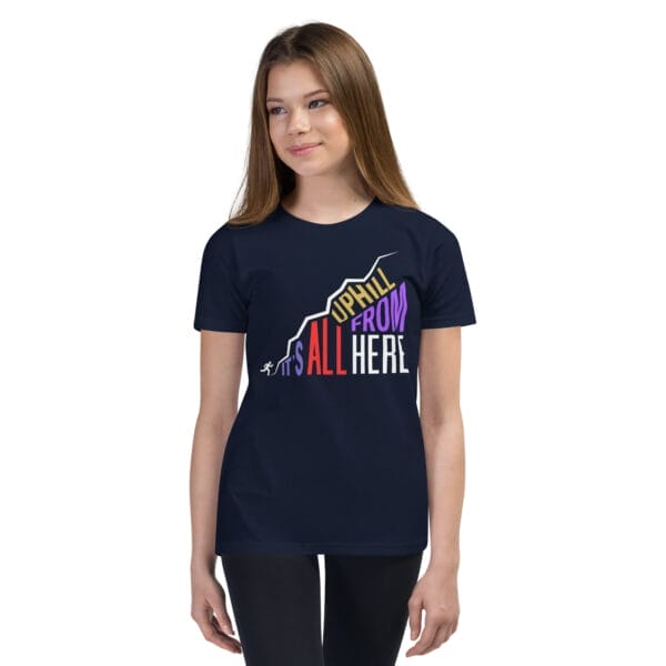 Young girl wearing a navy staple t-shirt with text "It's all uphill from here" in shape of a hill