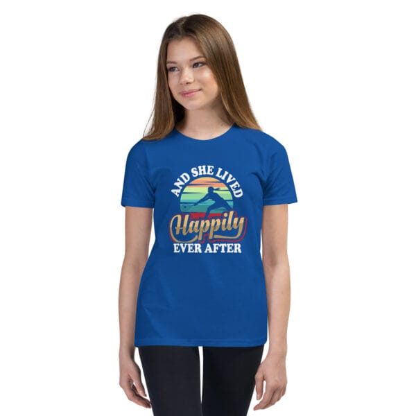 Young white girl wearing royal blue berry t-shirt with tennis player silhouette in front of colourful background and text 'And she lived happily ever after'