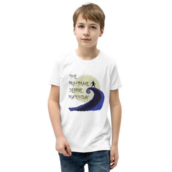 Young boy in white staple t-shirt with text 'The nightmare before matchday' and Ronaldo sii silhouette in front of moon