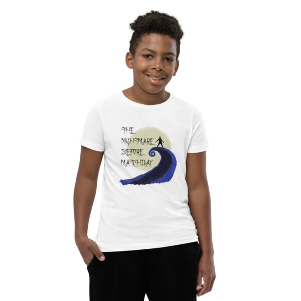 Young boy in white staple t-shirt with text 'The nightmare before matchday' and Ronaldo sii silhouette in front of moon