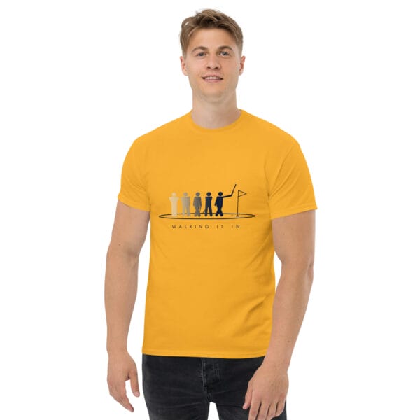 Man wearing a gold classic t-shirt with silhouettes getting darker of a golfer walking in their putt