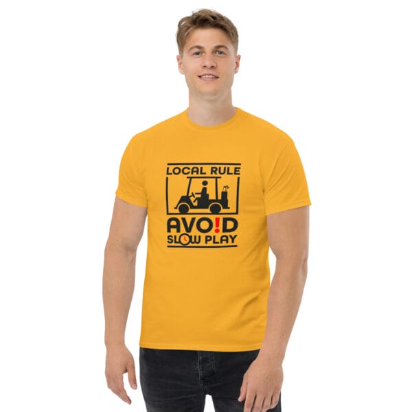 Man wearing gold classic tee in with text 'Local Rule Avoid Slow Play' with golf buggy silhouette