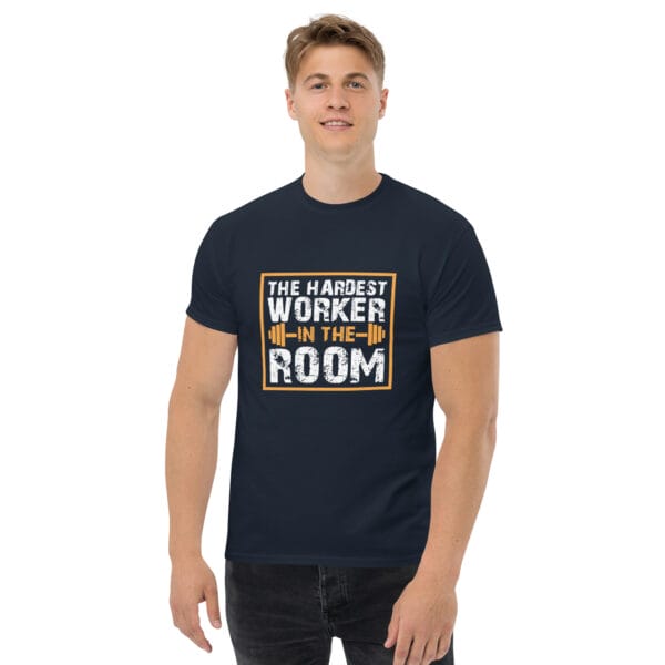 Man wearing navy classic tee with text 'The Hardest Worker in the Room' and barbell