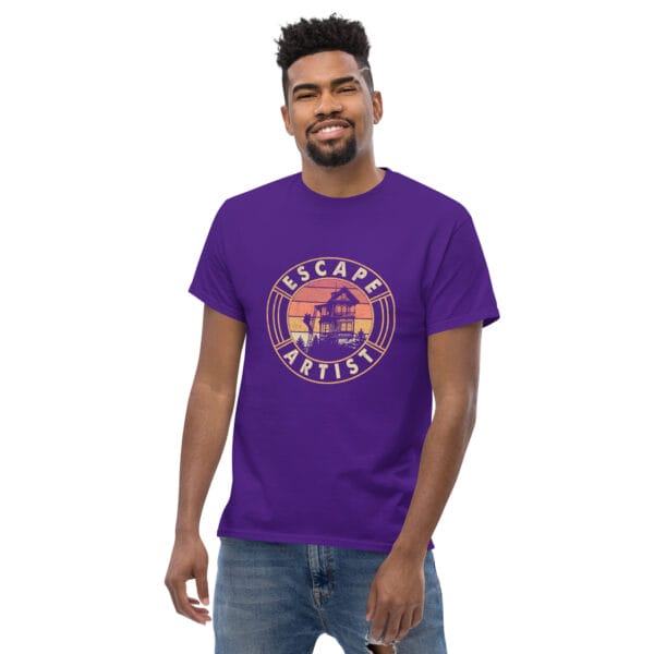 Man wearing a purple classic tee showing a golfer climbing down ladders from top floor of home with text 'Escape Artist'