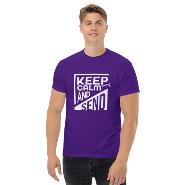 Man wearing a purple classic t-shirt with white text 'Keep Calm and Send' with small biker doing a superman air