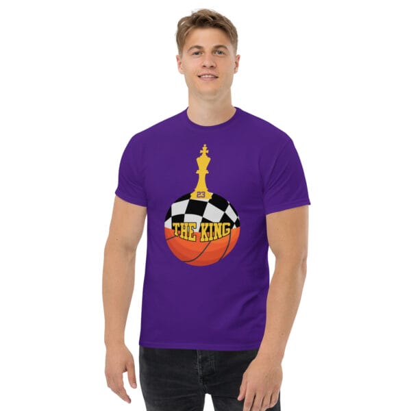 Man wearing classic tee in purple with text 'The King', a basketball with top half a chess board and King piece on top with number 23