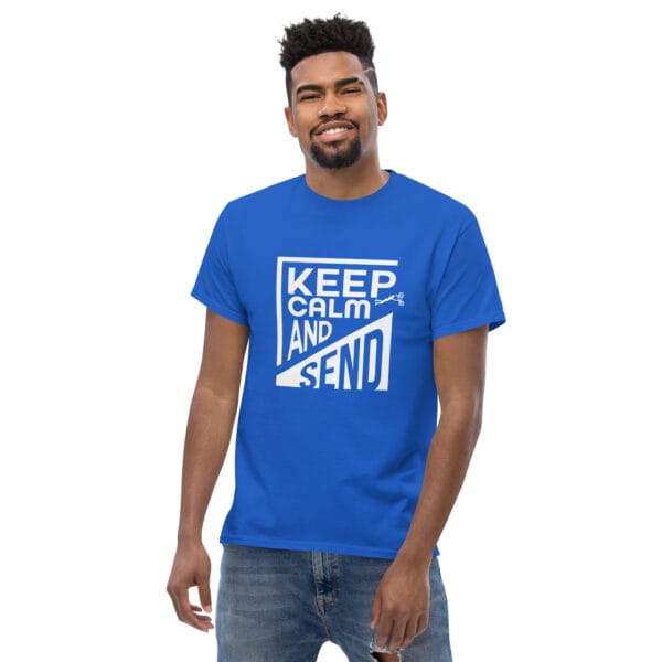 Man wearing a royal classic t-shirt with white text 'Keep Calm and Send' with small biker doing a superman air