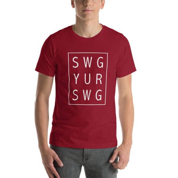 Man wearing cardinal unisex staple t-shirt with text 'SWG YUR SWG' meaning swing your swing in a 3 by 3 box