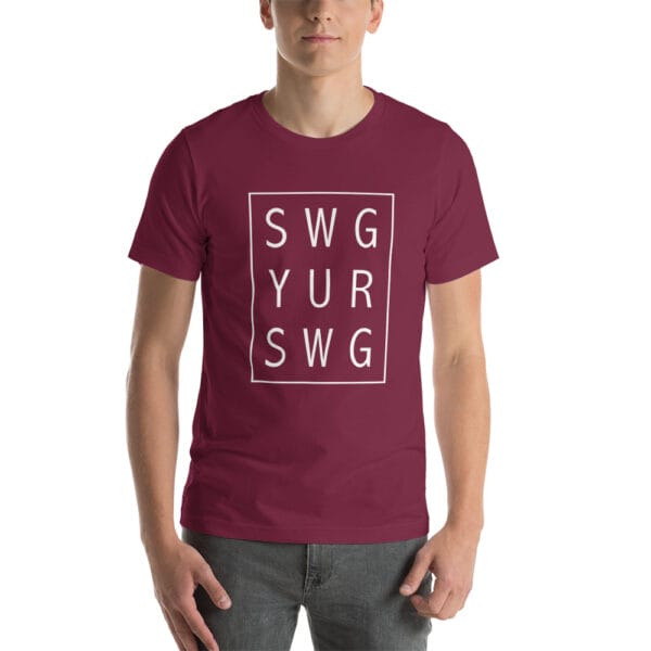 Man wearing maroon unisex staple t-shirt with text 'SWG YUR SWG' meaning swing your swing in a 3 by 3 box