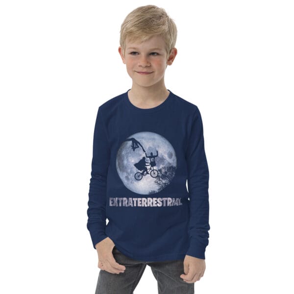 Boy wearing a navy youth long sleeve tee with Lionel Messi pointing to the sky and being touched by an extraterrestrial