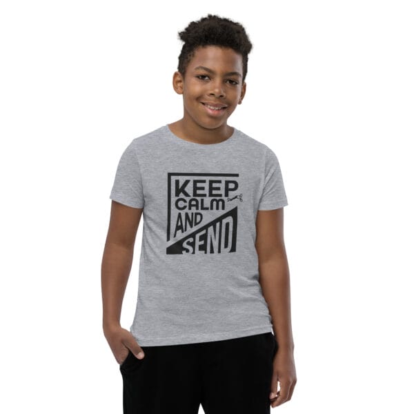 Boy in an athletic heather staple tee with black text 'Keep calm and send' and a small biker silhouette doing a superman