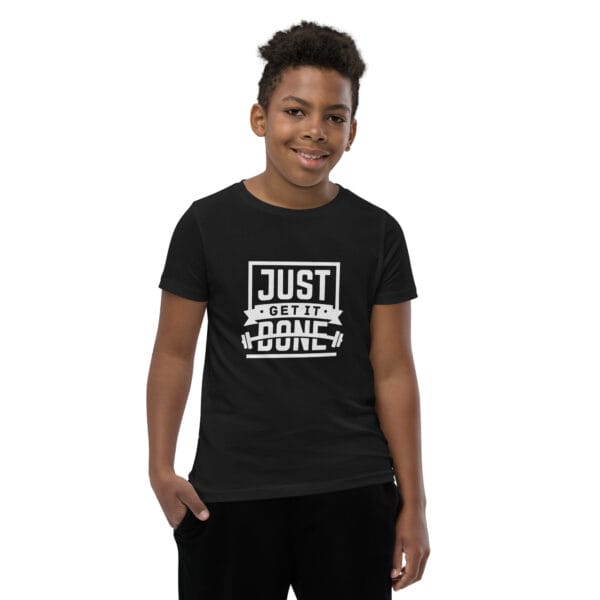 Boy wearing a black staple tee with large, white text 'Just get it done' and simple graphics