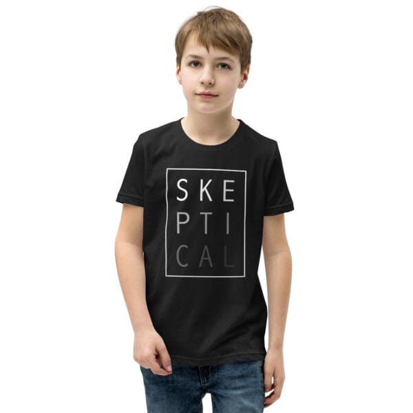 Boy wearing a black staple t-shirt with white text 'SKEPTICAL' fading out inside a box