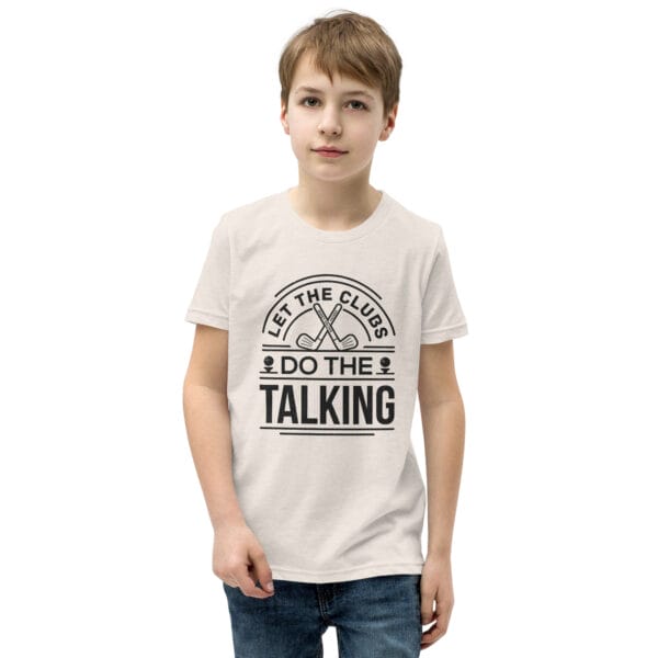 Boy wearing a heather dust staple t-shirt with black text 'Let the clubs do the talking'