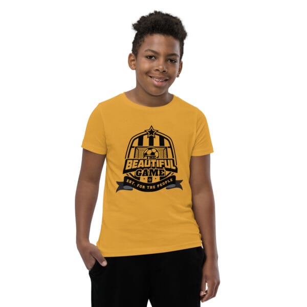 Boy in a mustard staple t-shirt with a black The Beautiful Game crest, est. for the people